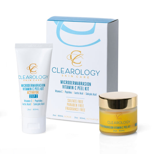 A set of Clearology Skin Care Microdermabrasion Vitamin C Peel Kit products, including a tube of Activator Step 2, a jar of Scrub Step 1 with a gold lid, and their matching white and blue packaging box. The labels mention ingredients like Vitamin C, Peptides, Lactic Acid, and Salicylic Acid.
