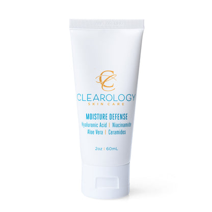 A close-up of the tube of Clearology Skin Care Moisture Defense. The label lists ingredients like Hyaluronic Acid, Niacinamide, Aloe Vera, and Ceramides, and mentions it is sulfate-free, paraben-free, and fragrance-free.